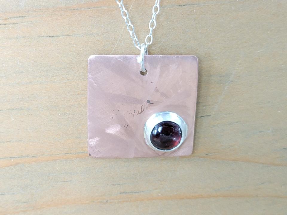 small copper and garnet charm necklace